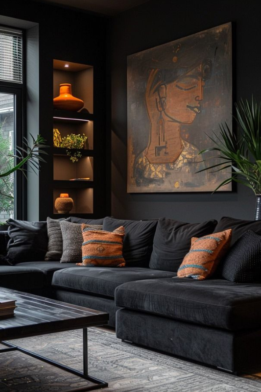 Bold black living room with a deep sectional sofa, orange patterned throw pillows, large ethnic-inspired artwork, inset display shelves with accent lighting, and a dark-toned area rug