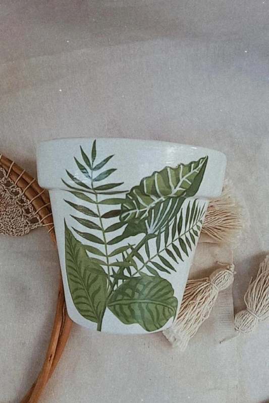 Elegant white planter pot decorated with detailed hand-painted tropical leaves in shades of green. This botanical-themed flower pot brings a serene, earthy feel to minimalist and nature-inspired home decor.