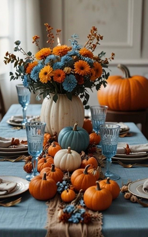 Bright blue and orange hydrangea centerpiece with mini pumpkins and a bold fall tablescape.